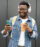 Portrait of a young African American man listening to music and enjoying coffee outdoors