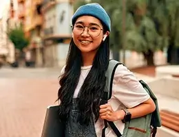 a student smiling outside