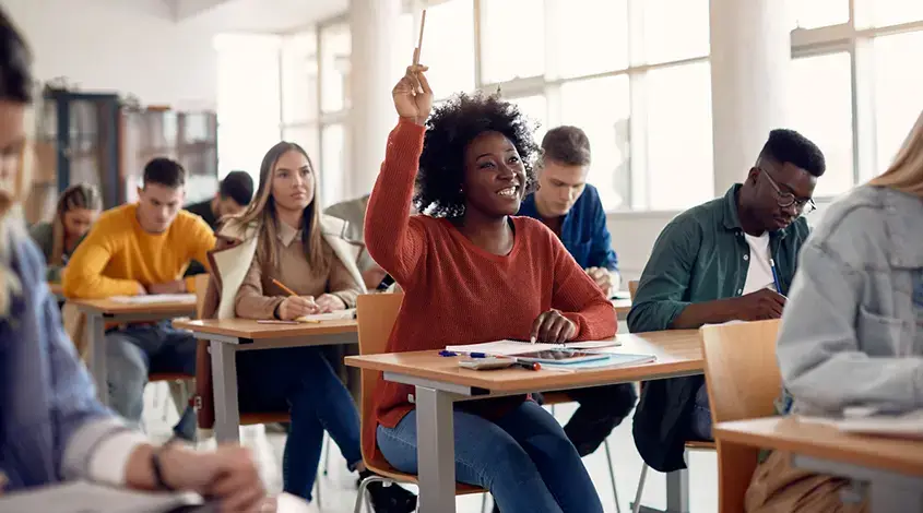 a student raising their hand in class